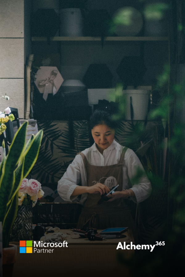 Picture of a woman, small business owner tending to her garden store.